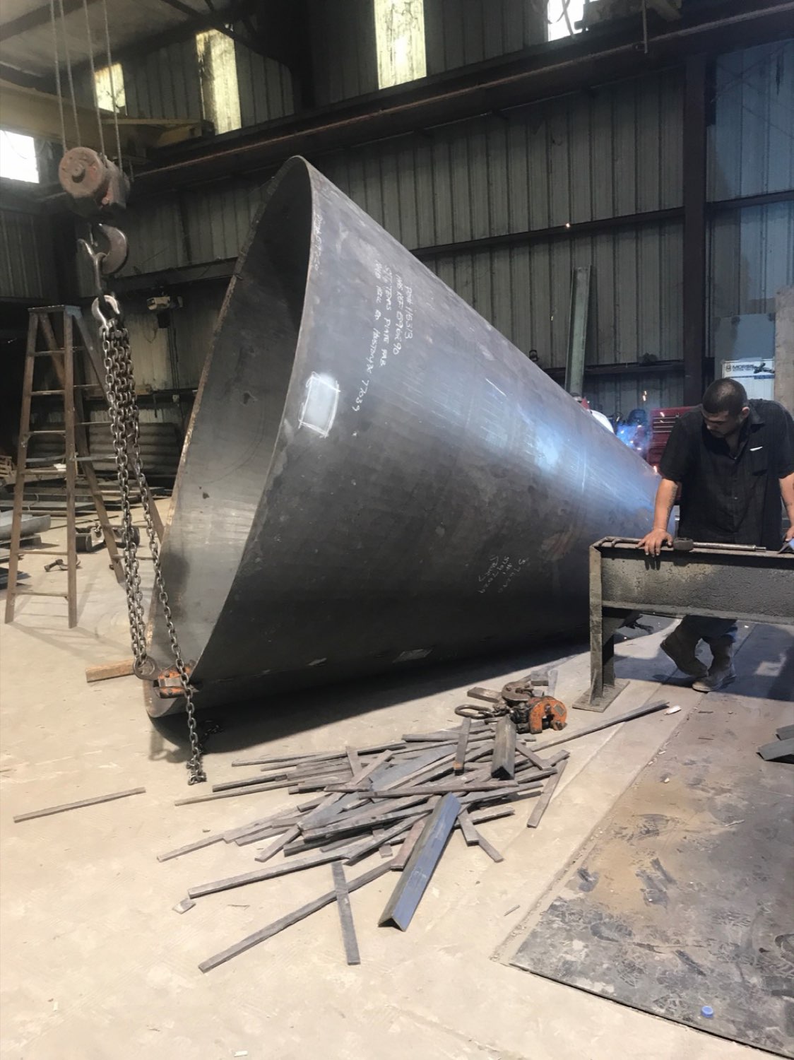 Large rolled steel cone being fitted in the shop