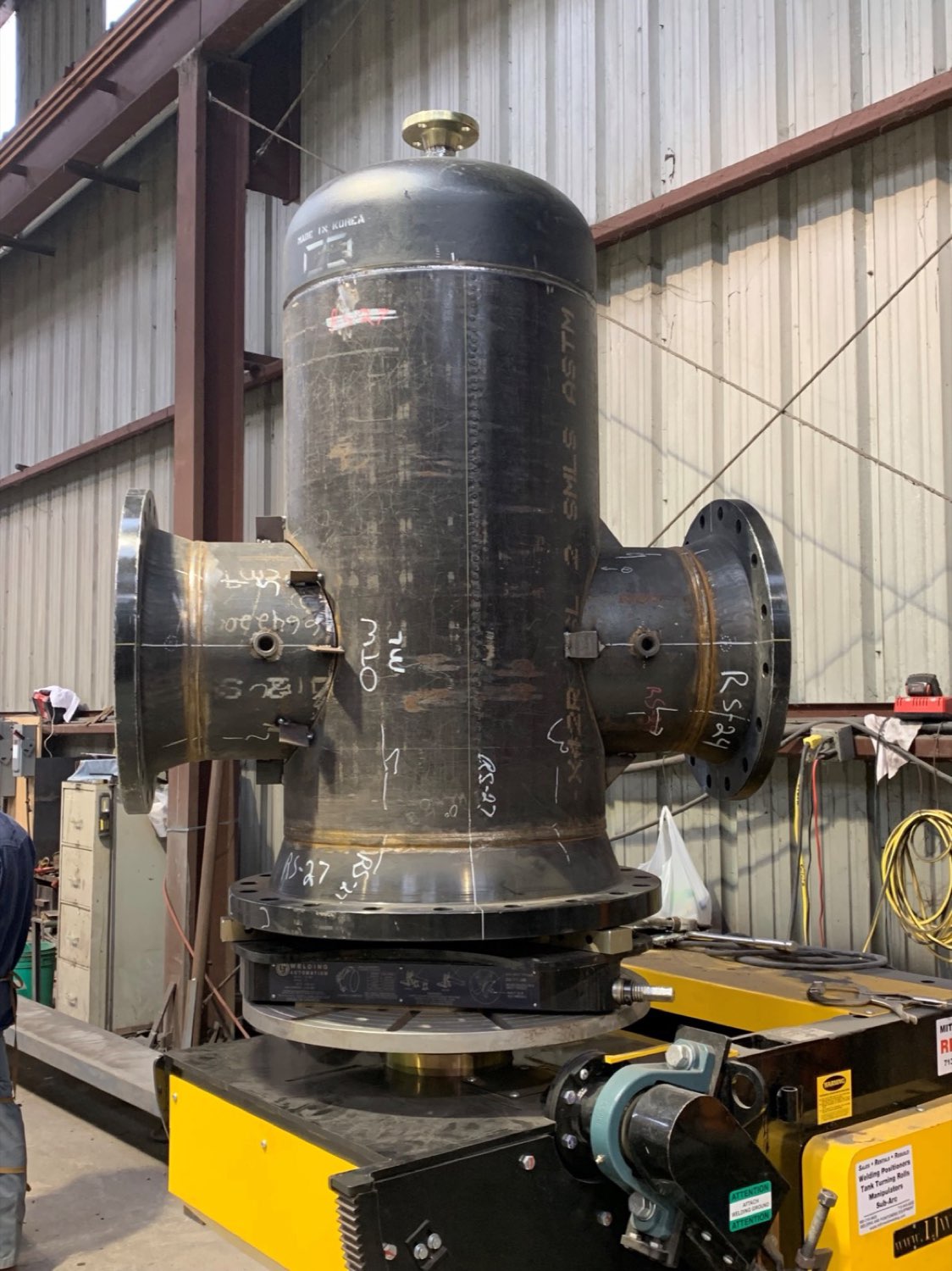 Fabricated pressure vessel on a turning roll in the Texas Plate Fabricators shop